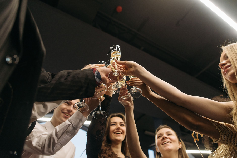 Colleagues raising glasses together at a team celebration