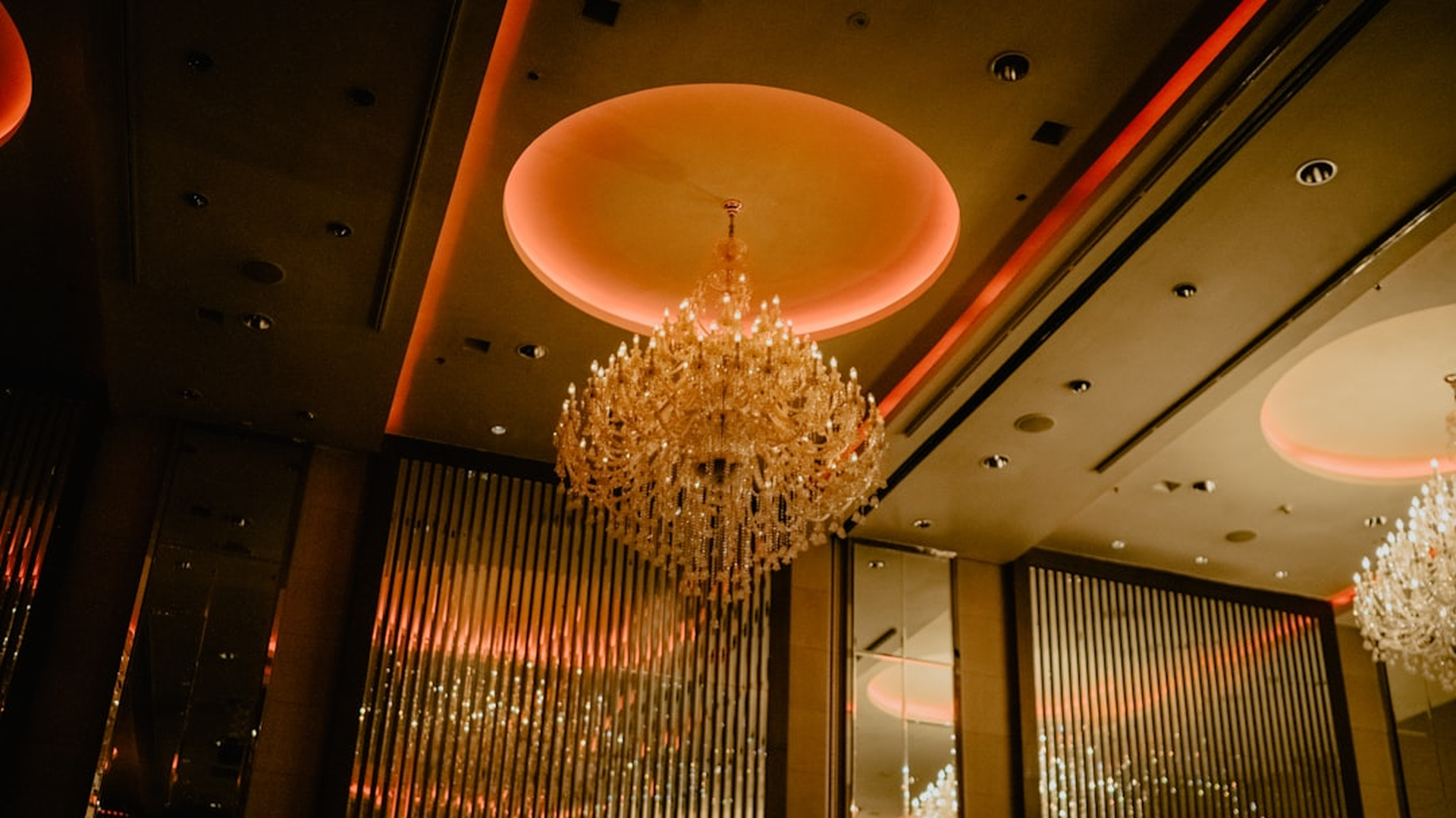 Ballroom chandeliers glowing over the gala